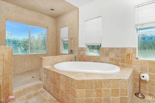 a bath tub sitting in a bathroom next to a window