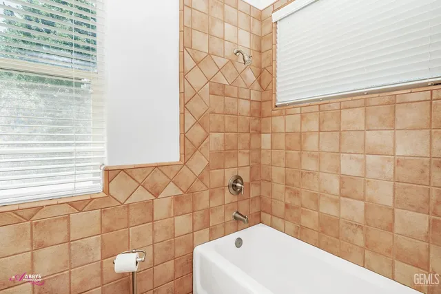 a bathroom with a bathtub and shower