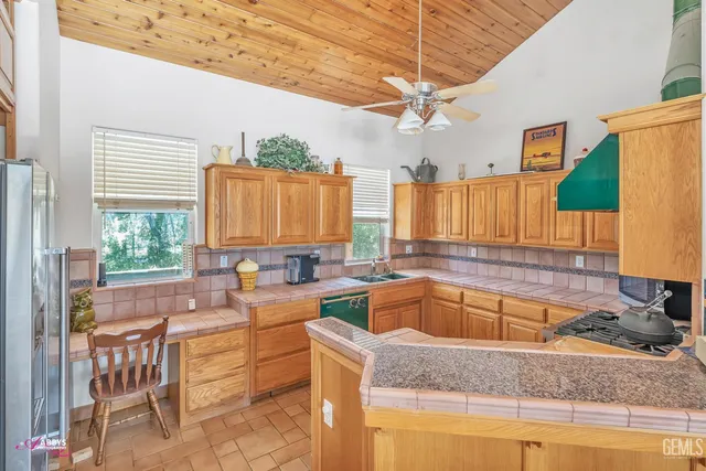 a kitchen with a stove a sink and a refrigerator