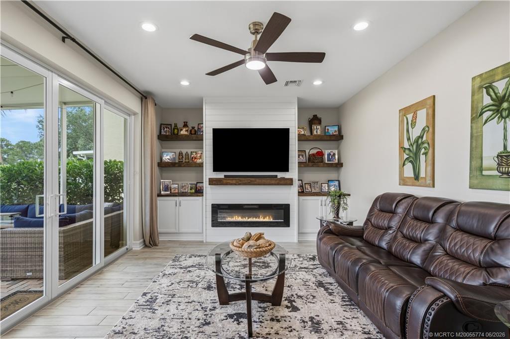 1268 Southeast Kirk Street Stuart, FL 34997 - Photo 3 of 63 a living room with furniture fireplace and window