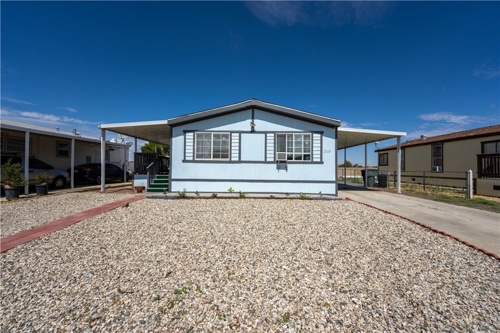 2103 Markey Way, Unit 8 Rosamond, CA 93560 - Photo 1 of 1 a front view of a house with a yard
