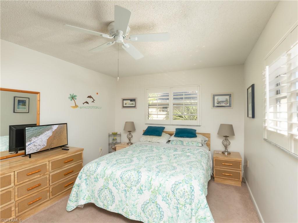 3325 Airport Road North, Unit E8 Naples, FL 34105 - Photo 6 of 7 a bedroom with a bed and wooden floor