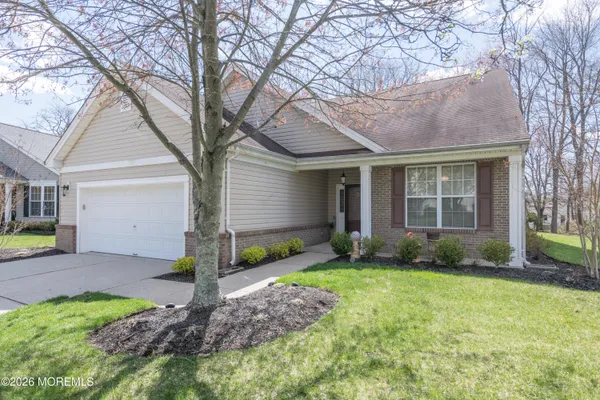 a view of a house with a yard and pathway