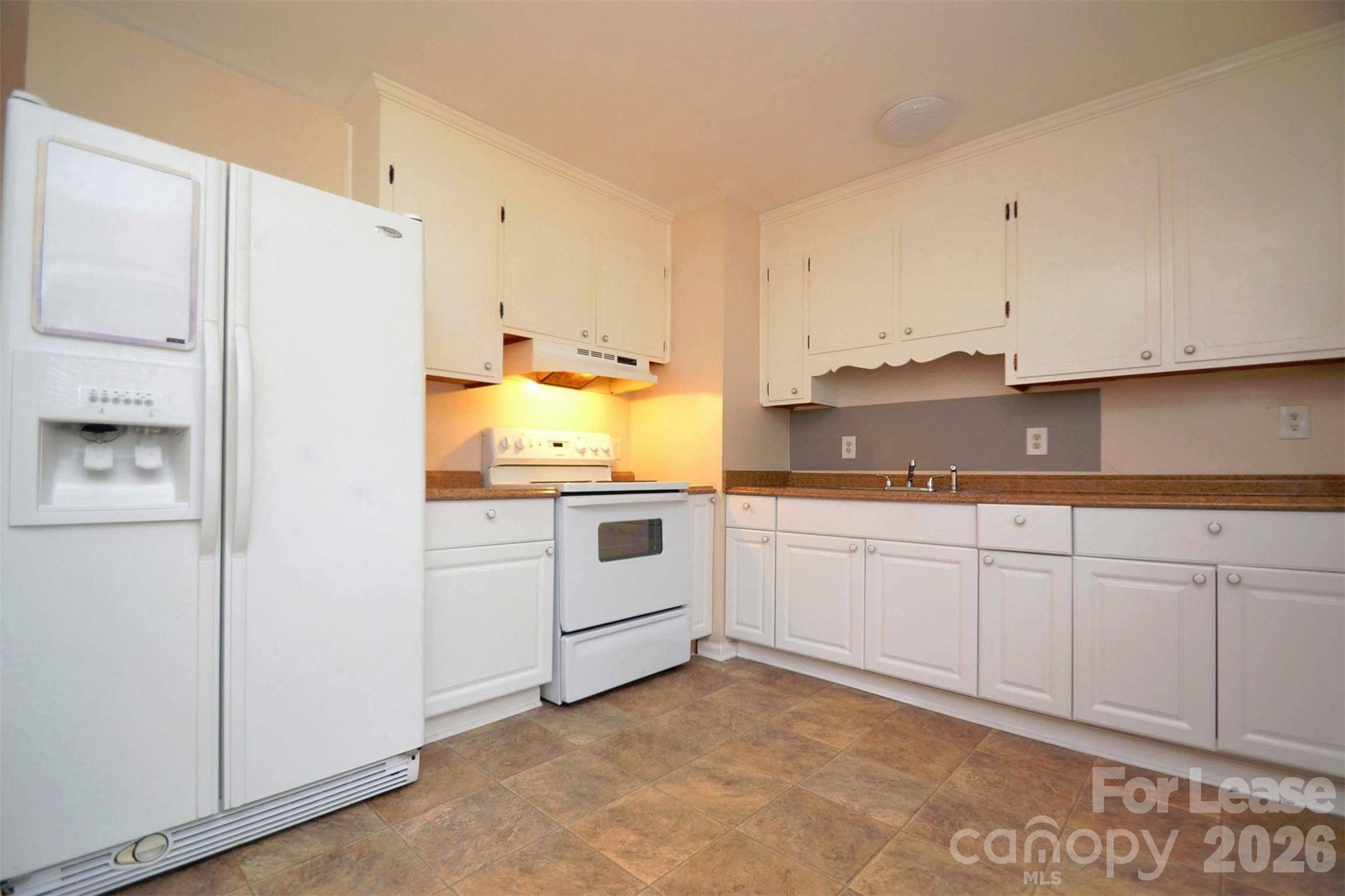 832 Tilden Road Charlotte, NC 28214 - Photo 8 of 13 a kitchen with granite countertop white cabinets and white appliances