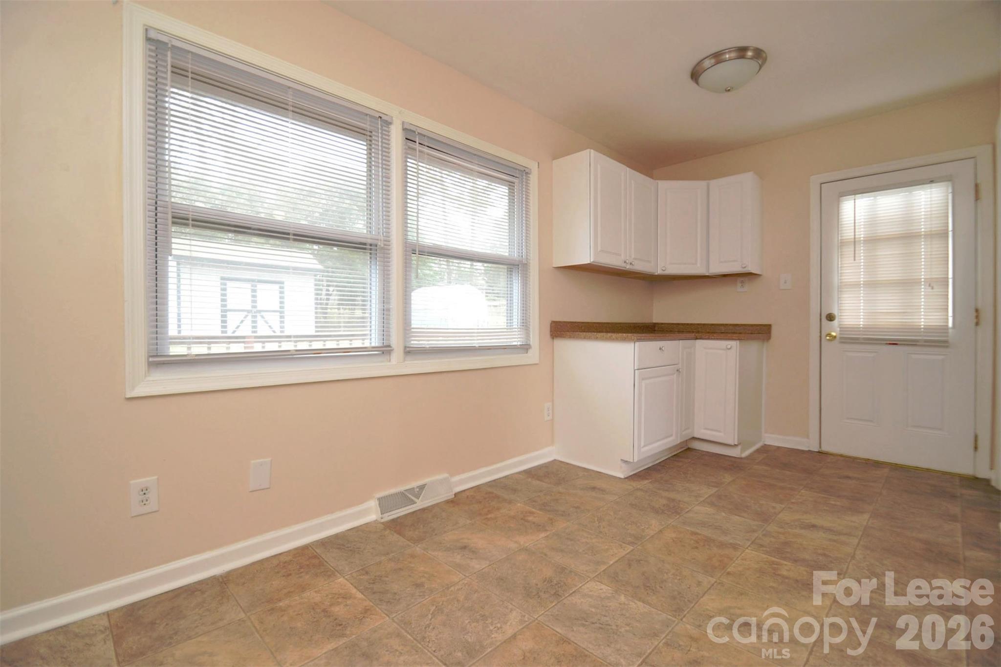 832 Tilden Road Charlotte, NC 28214 - Photo 9 of 13 an empty room with windows