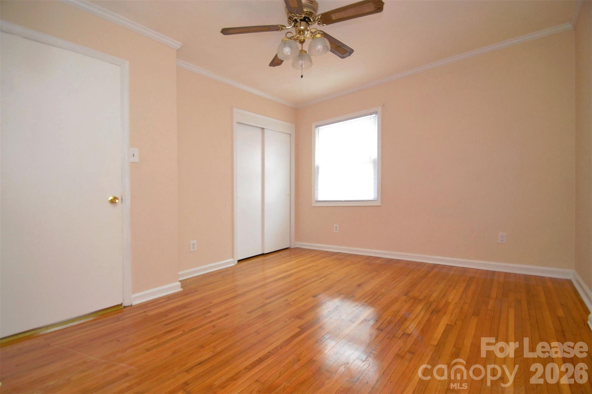 832 Tilden Road Charlotte, NC 28214 - Photo 10 of 13 an empty room with a window and wooden floor