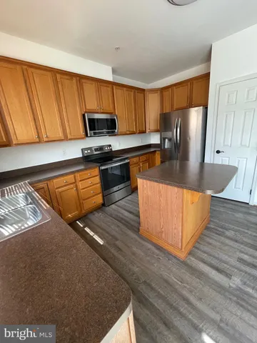 an empty room with closet and windows