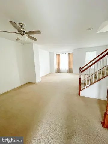 a kitchen with granite countertop wooden floors stainless steel appliances a sink and a window