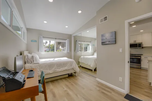 a bedroom with a large bed and a tv