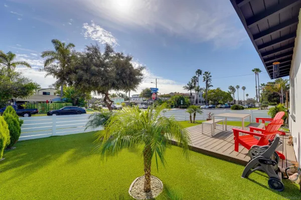 a view of swimming pool with outdoor seating and palm trees