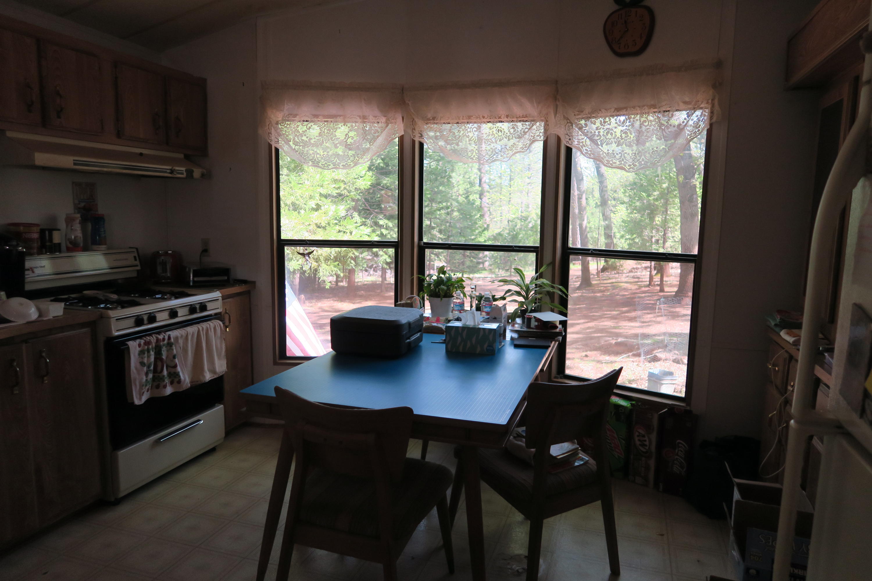 10814 Blue Mountain Ranch Road Whitmore, CA 96096 - Photo 2 of 11 a kitchen with a stove a sink and a refrigerator