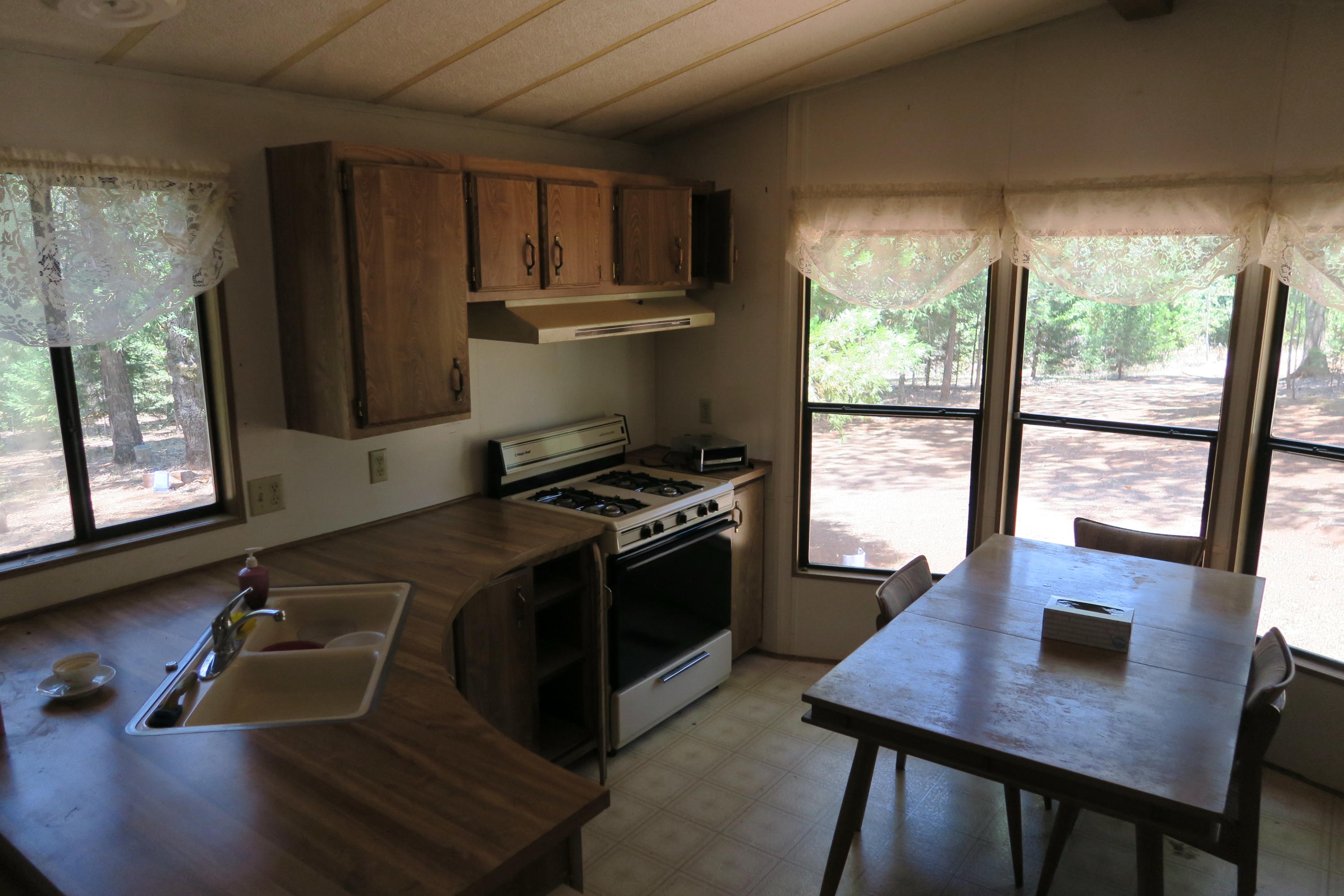10814 Blue Mountain Ranch Road Whitmore, CA 96096 - Photo 9 of 11 a kitchen with a sink appliances and a window