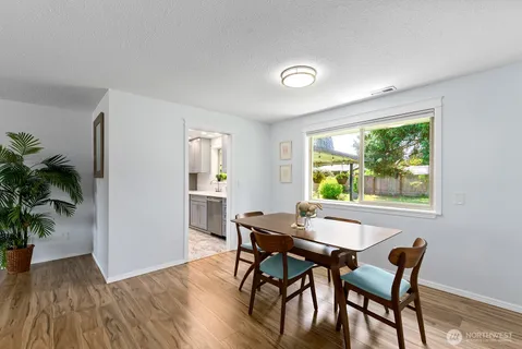 a view of a dining room with furniture window and wooden floor