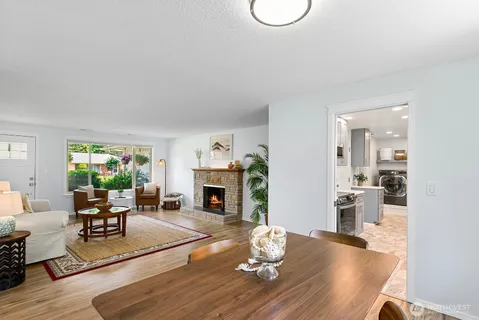 a living room with furniture a fireplace and a table