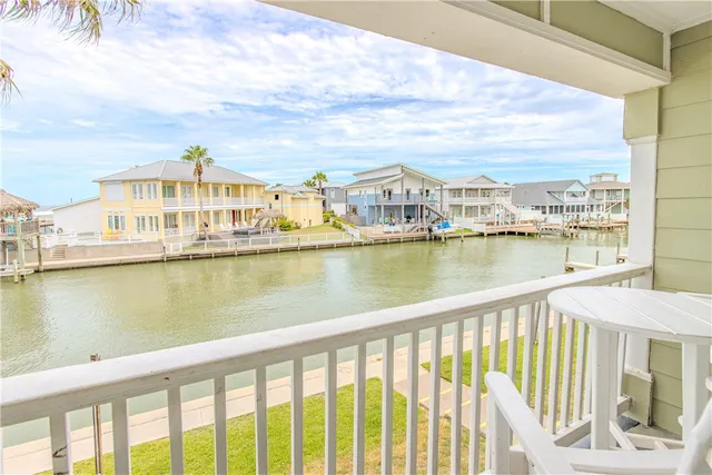 a view of a lake with a city from a balcony