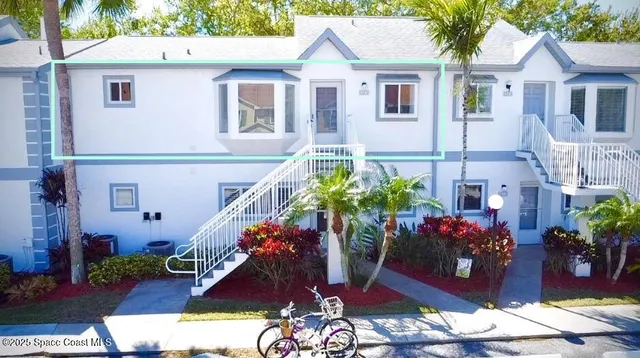 a view of a house with a yard and a garden