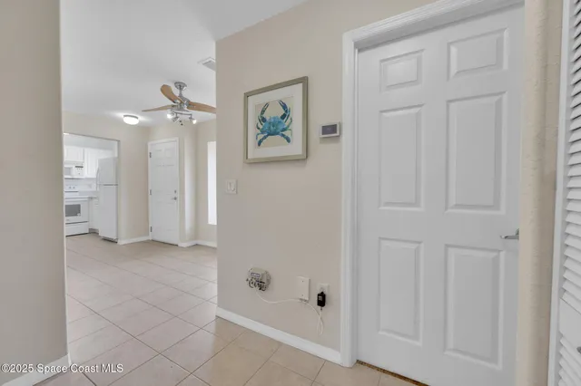 a view of a livingroom with a chandelier fan
