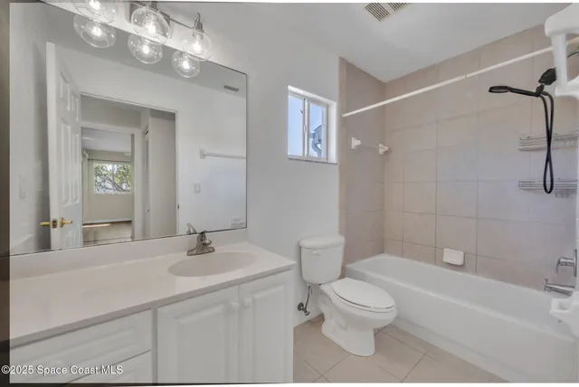 a bathroom with a toilet a sink a mirror and a bathtub