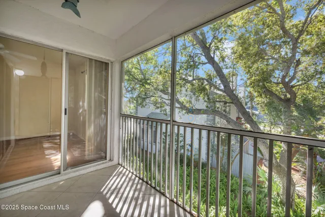 a view of balcony with wooden floor
