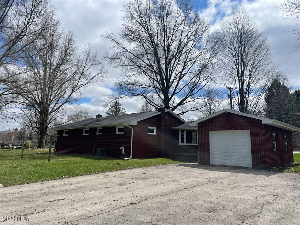 855 Georgetown Road Salem, OH 44460 - Photo 20 of 28 View of back of property with a driveway, an attached garage, brick siding, and a lawn