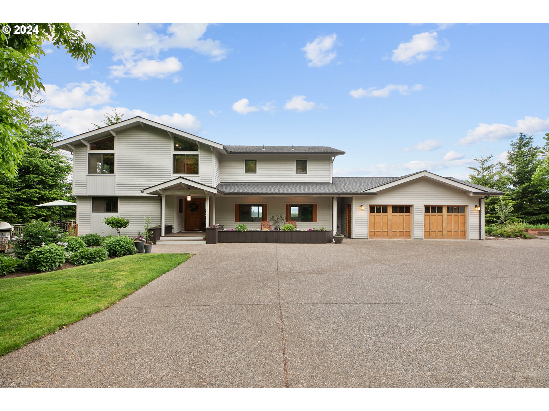 28900 Southwest Heater Road Sherwood, OR 97140 - Photo 2 of 48 a front view of a house with a yard and garage
