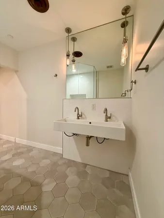 a bathroom with a sink and a mirror