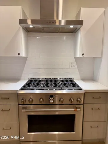 a stove top oven sitting inside of a kitchen