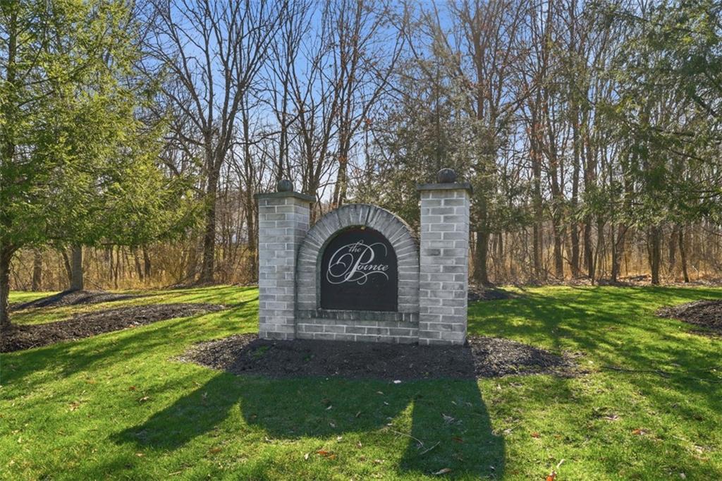 217 Adams Pointe Boulevard, Unit 11 Mars, PA 16046 - Photo 2 of 27 a front view of a house with garden