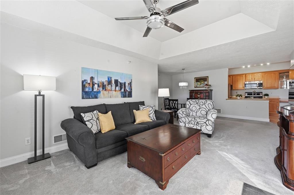 217 Adams Pointe Boulevard, Unit 11 Mars, PA 16046 - Photo 4 of 27 a living room with furniture and a large window