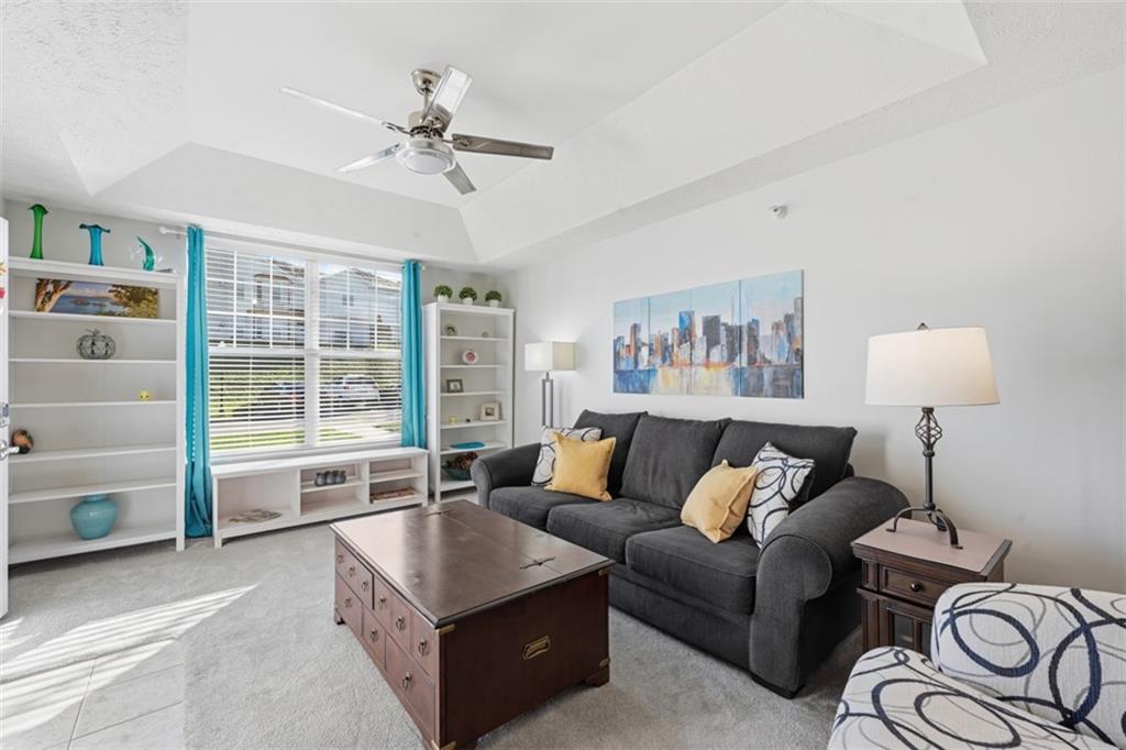 217 Adams Pointe Boulevard, Unit 11 Mars, PA 16046 - Photo 5 of 27 a living room with furniture and a large window