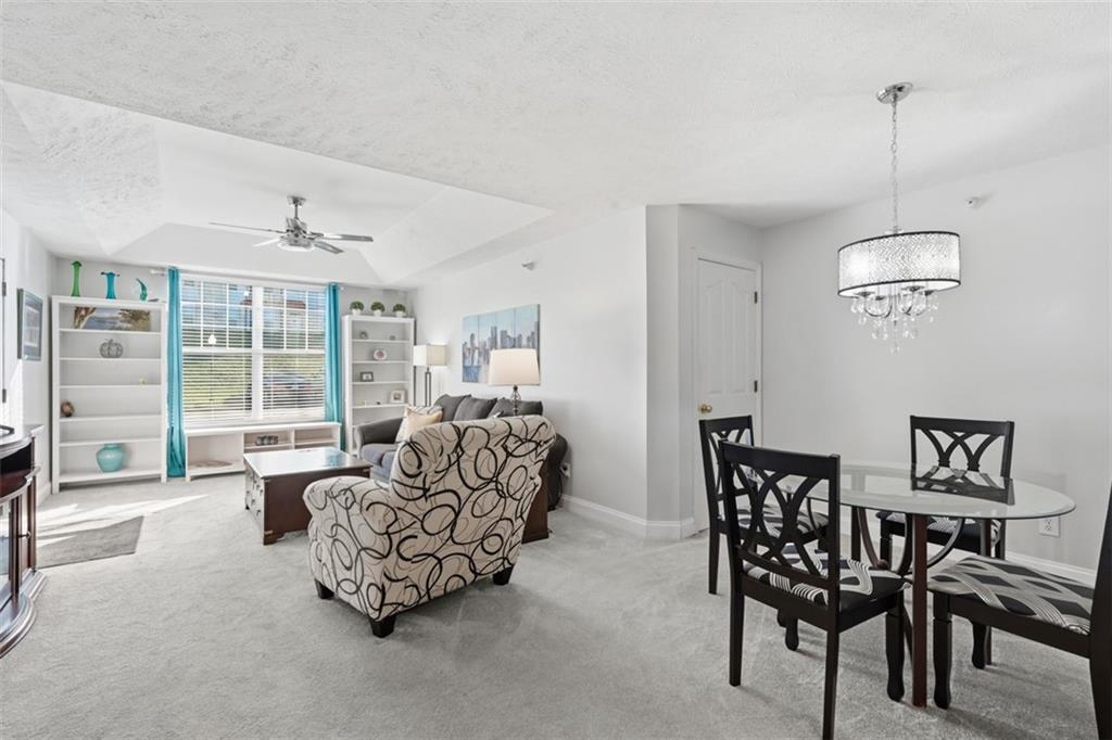 217 Adams Pointe Boulevard, Unit 11 Mars, PA 16046 - Photo 7 of 27 a living room with furniture and a large window