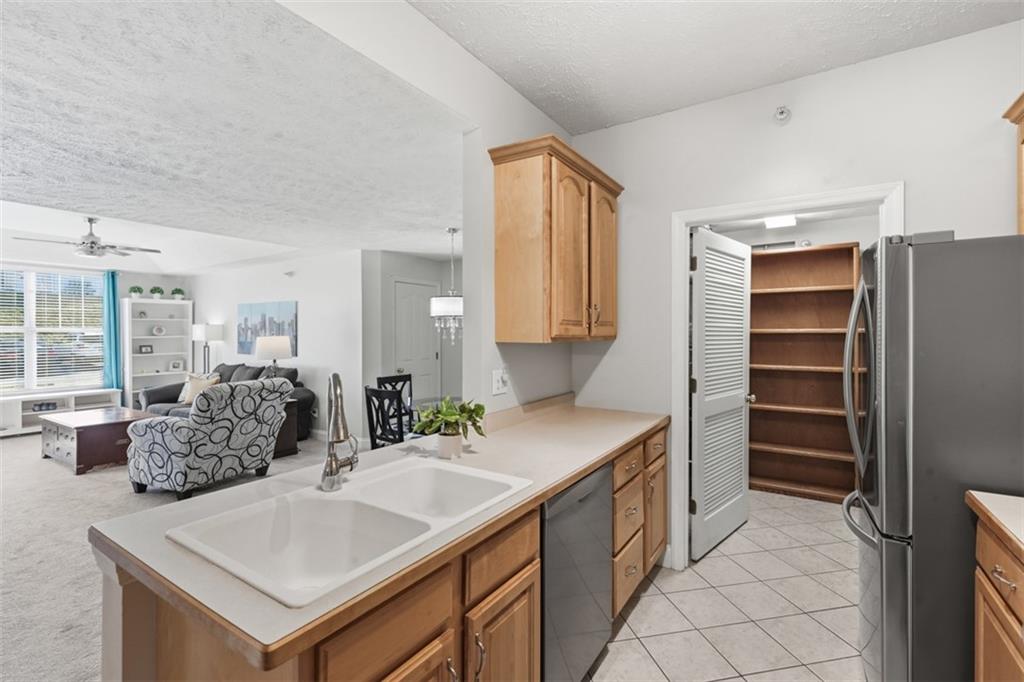 217 Adams Pointe Boulevard, Unit 11 Mars, PA 16046 - Photo 9 of 27 a kitchen with stainless steel appliances granite countertop a sink and a refrigerator