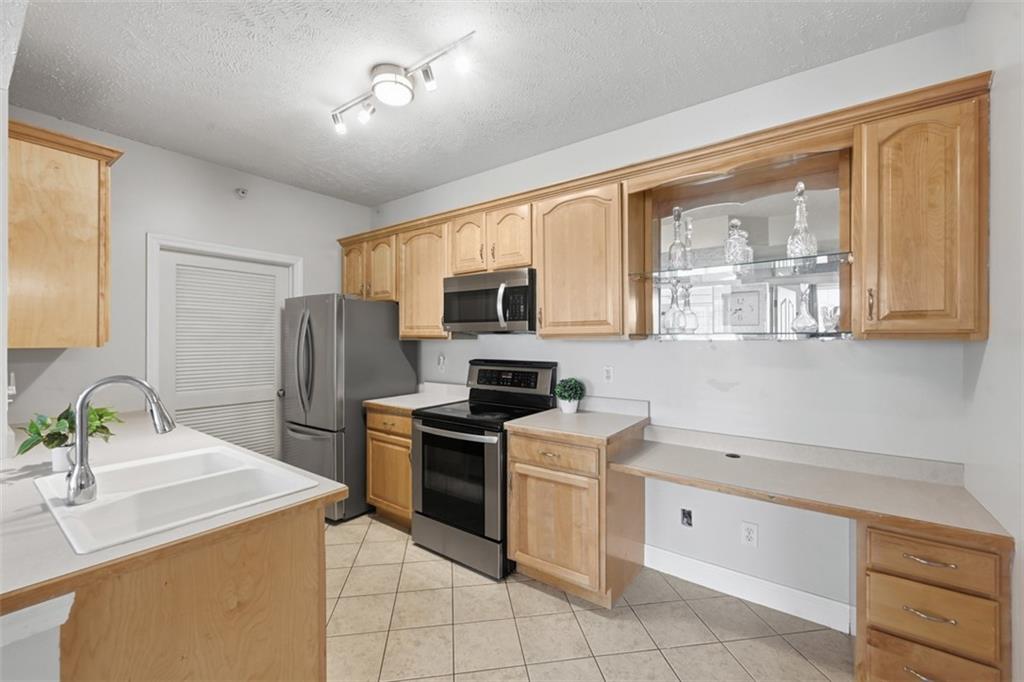 217 Adams Pointe Boulevard, Unit 11 Mars, PA 16046 - Photo 10 of 27 a kitchen with a sink stove and refrigerator