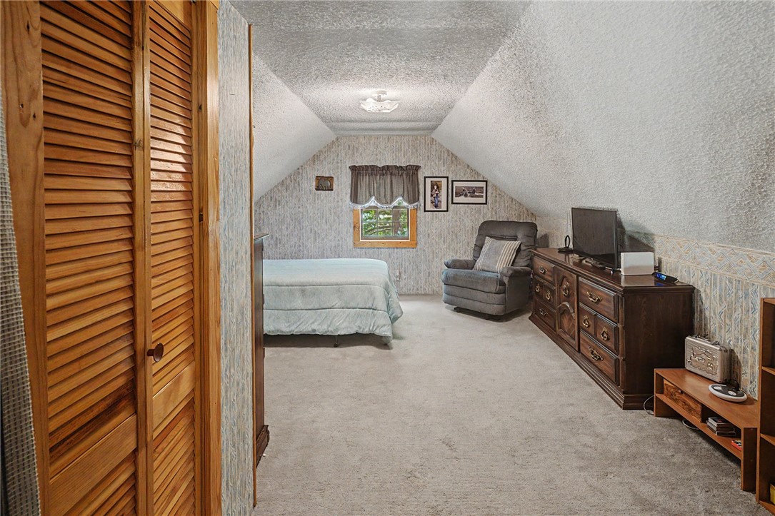 21019 Carter Road West Fork, AR 72774 - Photo 38 of 49 Carpeted room featuring sloped ceilings and a window with wood trim