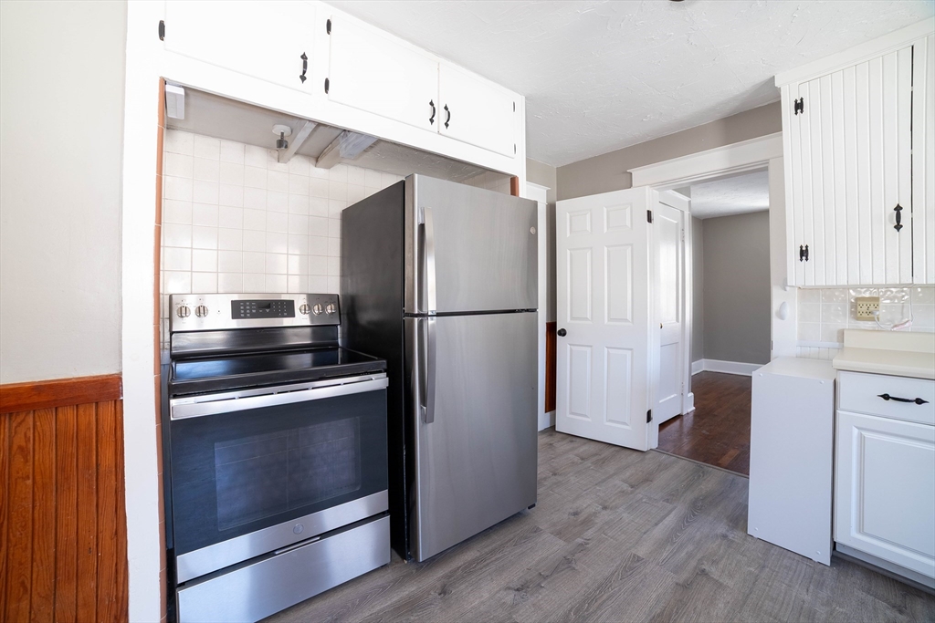 5 Maple Avenue, Unit 2 Oxford, MA 01537 - Photo 10 of 22 a kitchen with stainless steel appliances a refrigerator stove and sink