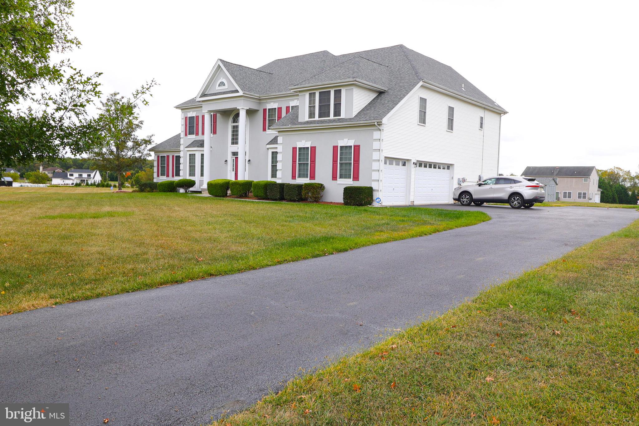 2 Edgewood Drive Pittsgrove, NJ 08318 - Photo 2 of 78 a view of a white house next to a yard and road