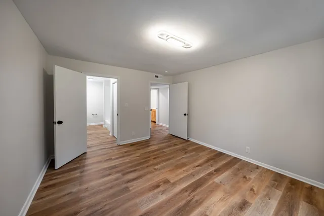 a view of an empty room and wooden floor