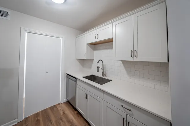 a kitchen with a sink and cabinets