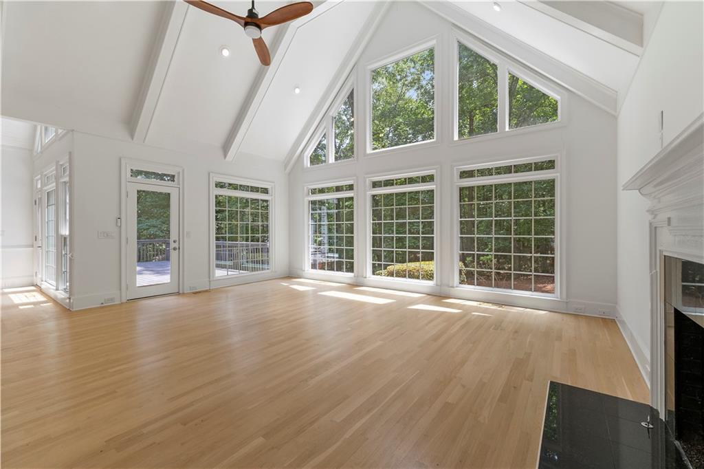 8965 Laurel Way Alpharetta, GA 30022 - Photo 8 of 79 a view of an empty room with wooden floor and a window