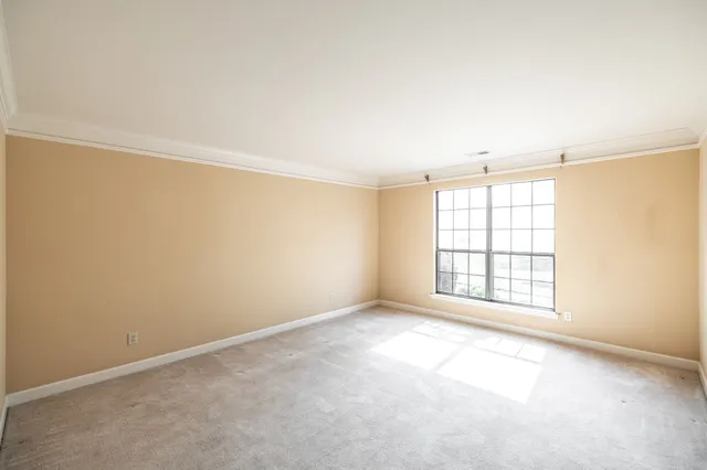 an empty room with a empty space and windows