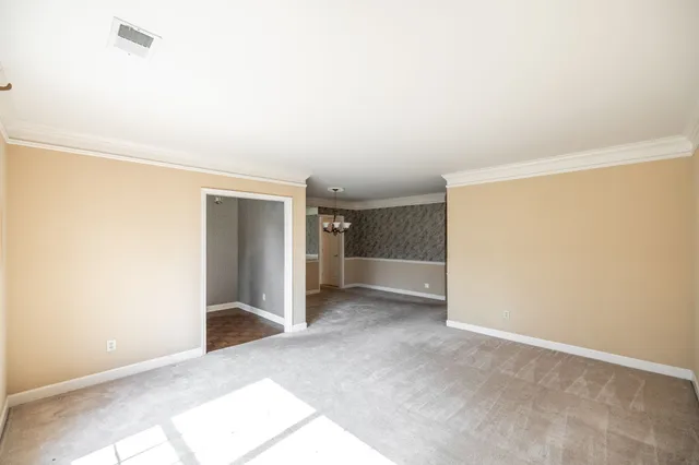 an empty room with closet and windows