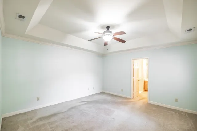 an empty room with a window and a ceiling fan
