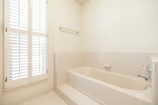 a white bath tub sitting next to a window