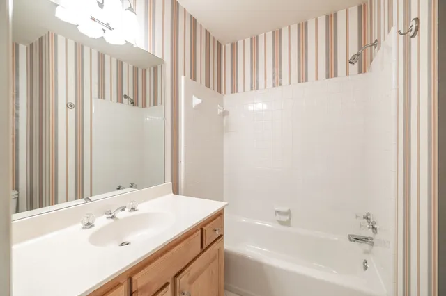 a bathroom with a sink a mirror and a bathtub