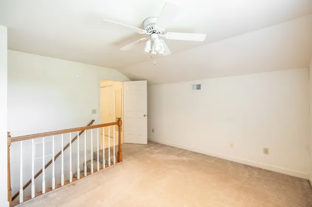 a view of a hallway with a chandelier fan