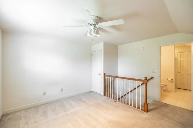 a view of a hallway with a ceiling fan