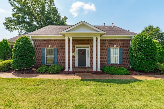 a front view of a house with garden