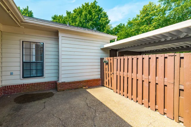 a backyard of a house with plants and trees