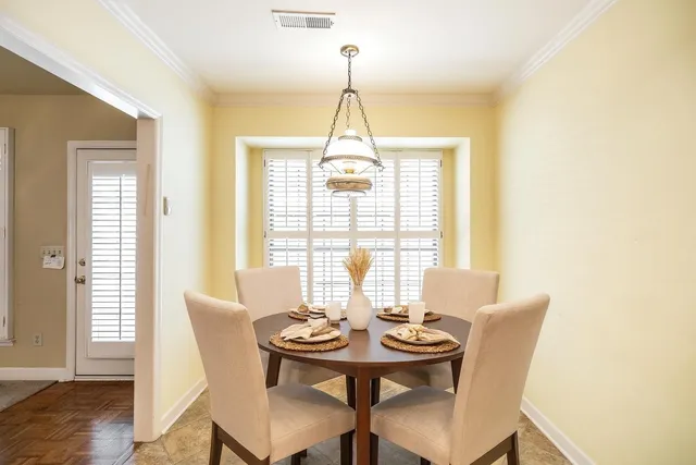 a dining room with furniture and window