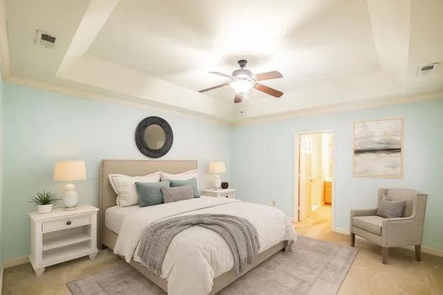 a bedroom with a bed and a chandelier